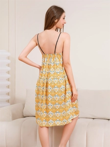 Detail of the open back design and vintage floral print on a yellow summer nightdress