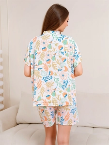 Rear view of women's short-sleeved pajama set with orange floral and blue leaf prints