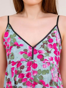 Detailed view of the V-neckline and floral print on a light blue summer strap dress