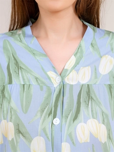 Detail of V-neck buttoned pajama top with fresh tulip floral print on light blue fabric