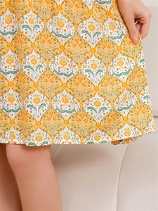 Detailed close-up of summer rayon nightgown featuring orange pomegranate floral print