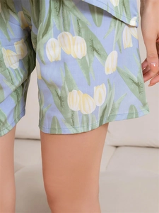 Detail of tulip print and stitching on light blue cotton pajama shorts for women