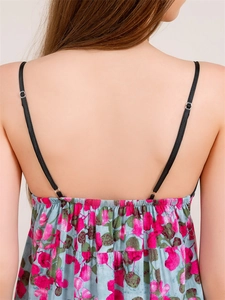 Detail of adjustable black shoulder straps and elastic back on floral print summer dress