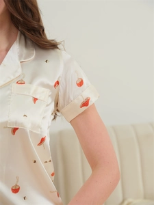 Detail of ice silk pajama top featuring a mushroom print with lapel and breast pocket