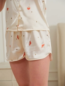 Detail of ice silk pajama set with mushroom prints and side slit on the shorts