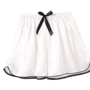 Elegant pearl white satin pajama shorts with black bow detail and elastic waist