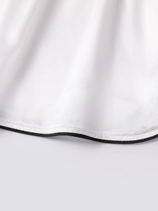 Detail of white ice silk shorts with black piping and professional double-stitch hem