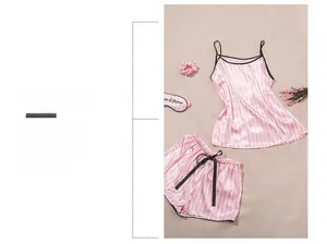 Close-up of pink striped silk pajamas featuring a camisole, shorts, and matching eye mask