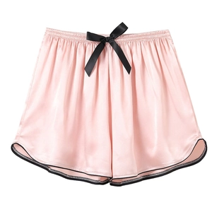 Women's pink ice silk pajama shorts with black bow and satin trim in minimalist style