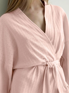 Detail of pink knitted robe with diamond pointelle texture and waist tie closure
