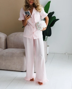 Pink checkered cotton pajama set with ruffle details and matching floral bag