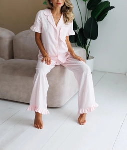 Detail of pink cotton pajama set with ruffled sleeves and textured jacquard fabric