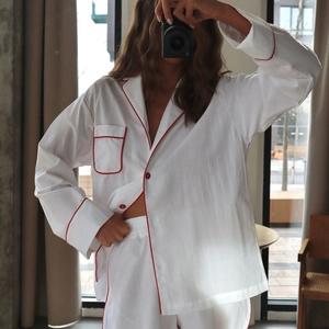 Minimalist white cotton lounge set with red piping detail, long sleeves and shorts