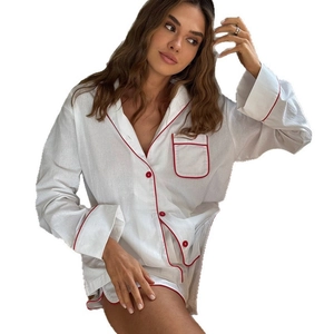 Women's two-piece white cotton loungewear set with red piping and button details