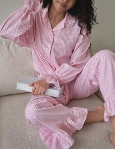 Detailed view of pink gingham pajama set featuring ruffled cuffs and matching hem accents