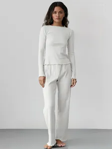 Detail of grey knitted pajamas with ruffle cuffs and textured ribbed fabric