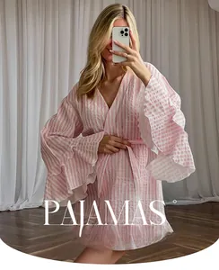 Detail of pink striped cotton robe featuring ruffled flare sleeves and crinkle texture
