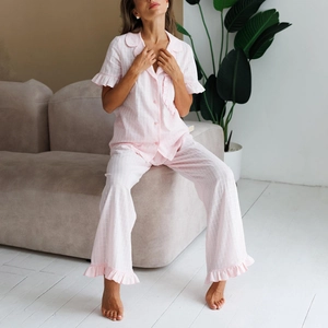 Pink cotton pajamas set for women with ruffled short sleeve top and wide leg pants