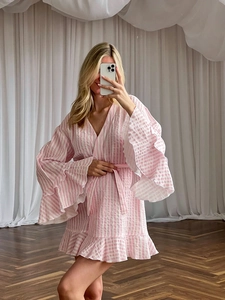 Detail of pink and white striped cotton crepe bathrobe with ruffle sleeves and waist tie