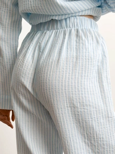 Detailed macro view of high-waist elastic band on striped cotton pajama pants