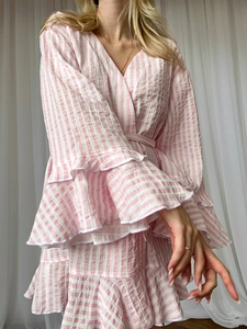 Detail showing pink striped crepe cotton robe with ruffled cuffs and a wrap V-neckline