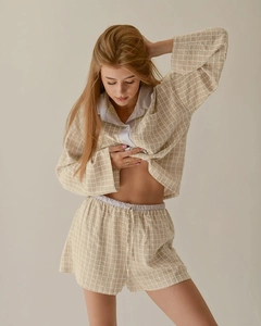 Detailed view of beige checkered long sleeve shirt and shorts set with soft texture