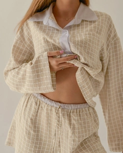 Detailed view of women's plaid pajama set featuring lapel collar and button-down design