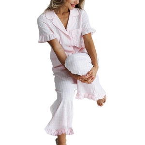 Women's light pink plaid cotton pajama set with ruffle trim and button-down short sleeves