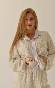 Close-up of women's long sleeve plaid pajama set with contrast collar and buttons