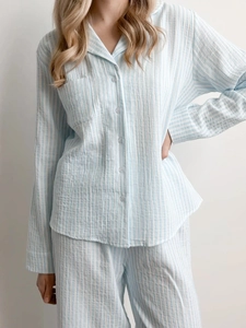 Detail of light blue striped cotton gauze pajama set with button-up top and breast pocket