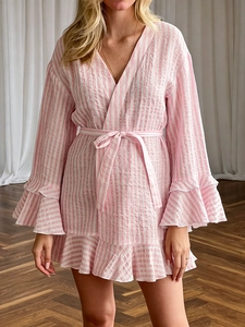 Detail of pink and white striped cotton robe with ruffled hem and V-neckline