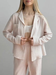 Detail of pink and white striped seersucker pajamas set with button-down collar and chest pocket