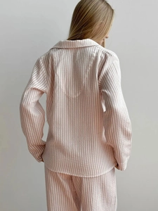 Detail view of pink and white striped cotton pajamas set with breathable crinkle texture