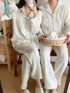 Matching couple pajamas set with vertical stripes in breathable seersucker cotton fabric