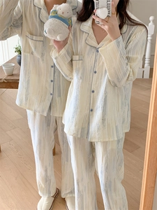 Detail view of cotton couple pajamas set with blue piping and artistic brush stroke patterns