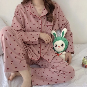 Close-up of pink long-sleeved pajamas with red heart prints and soft brushed fabric