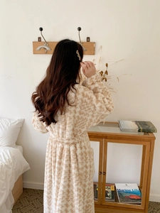 Detailed back view of a long, thick checkered flannel bathrobe with a waist tie design