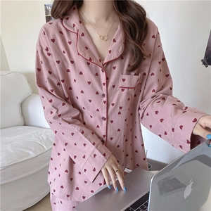 Cozy autumn pajama set detail showing soft heart-patterned fabric and lapel piping