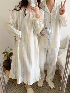 Detail of couple's cotton pajama set with blue stripes, ruffles, and soft gauze texture