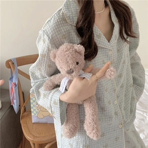 Détail du pyjama à carreaux bleu clair avec motifs d'ours et col à revers boutonné classique