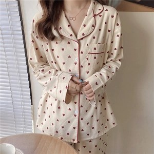 Detail of sweet heart print pajama set with red piping and chest pocket for women