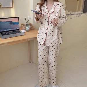 Detail of sweet heart pattern long-sleeved pajama set with contrast red piping trim