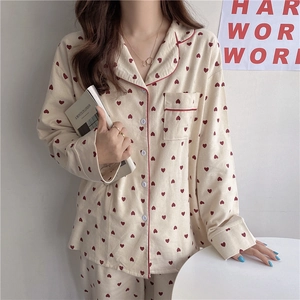 Detail of soft heart print pajama top with red piping and chest pocket for women