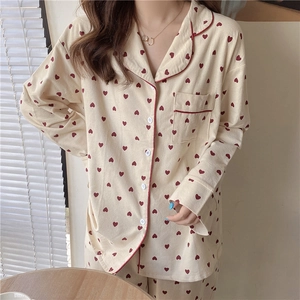 Detail of soft cream pajama top with red heart pattern, lapel collar and pocket