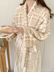 Detail of soft plush flannel texture on long beige wavy pattern bathrobe for women