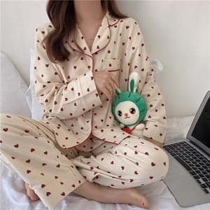 Close-up of heart print pajamas with red piping and button-down collar detail