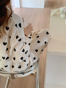 Detailed texture of cotton gauze pajama set featuring a black heart pattern