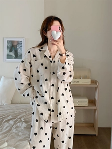 Detail of soft cotton gauze pajamas with black heart prints and button-down collar