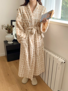 Detail of a thick long houndstooth bathrobe featuring a waist tie and side pockets