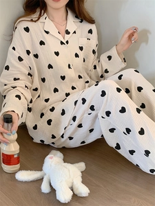 Detail of soft cotton gauze pajama set with black heart print and button-down shirt style